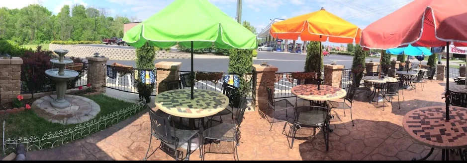 Outdoor patio at Cazadores with colorful umbrellas and a fountain