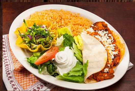 Mexican entrée served with rice, salad and sour cream